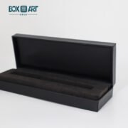 a black pen box with a long rectangular object